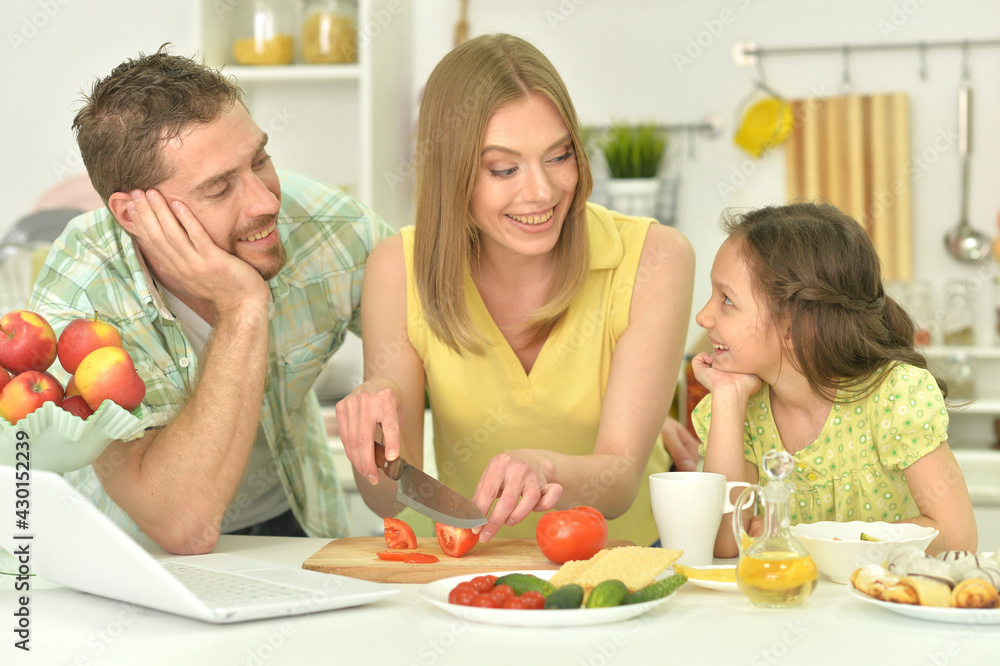 family cooking together at kitchen table family cooking together at kitchen table