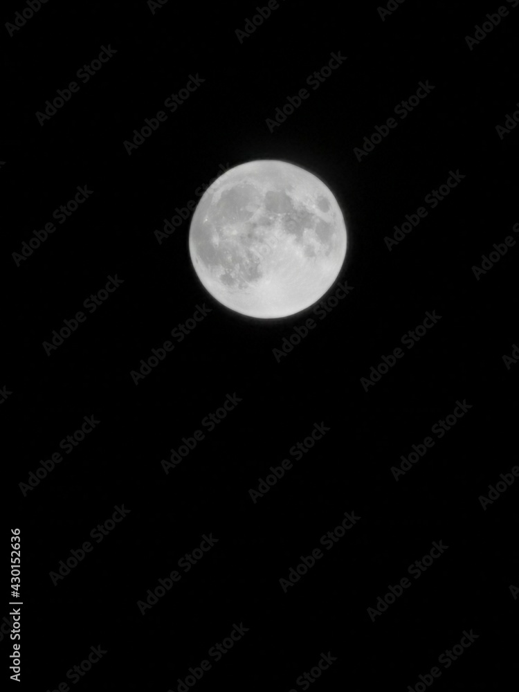 Full moon on a black background by night. Full moon on a black background by night.
