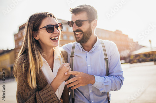 Couple in love walking embracing in street on romantic trip