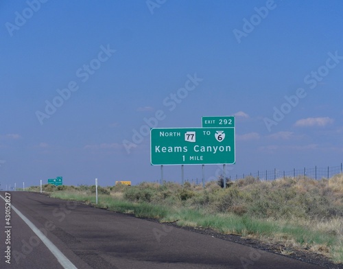 Directional sign on the road in Arizona with distance to Keams Canyon.