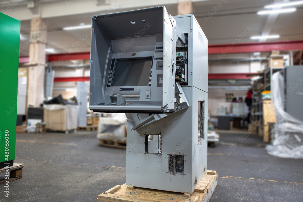 Hacked ATM machine with cut holes in the safe. An empty ATM from which money was stolen. Hacked ATM machine with cut holes in the safe. An empty ATM from which money was stolen.