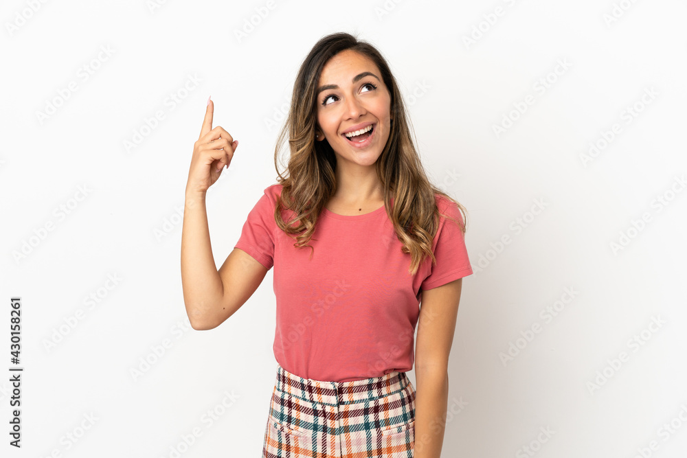 Young woman over isolated background pointing up and surprised Young woman over isolated background pointing up and surprised