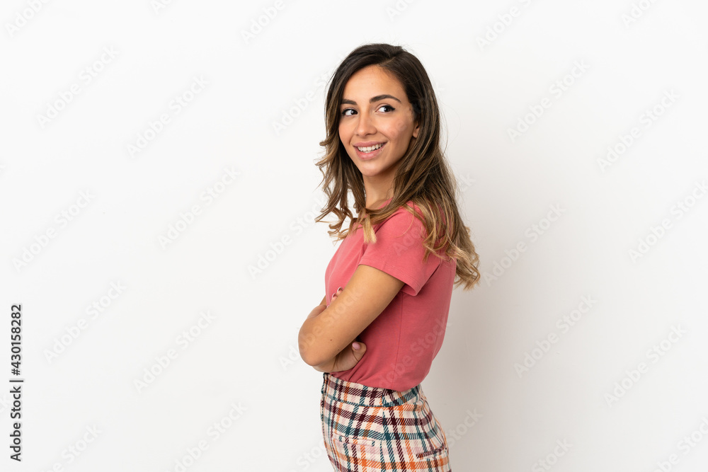 Young woman over isolated background looking to the side and smiling Young woman over isolated background looking to the side and smiling
