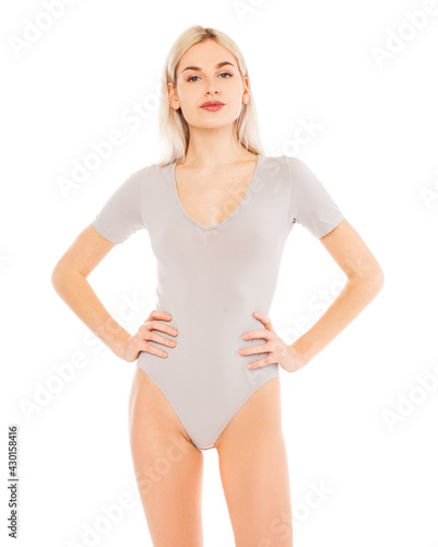 Portrait of a young blonde woman in gray bodysuit © Andrey_Arkusha