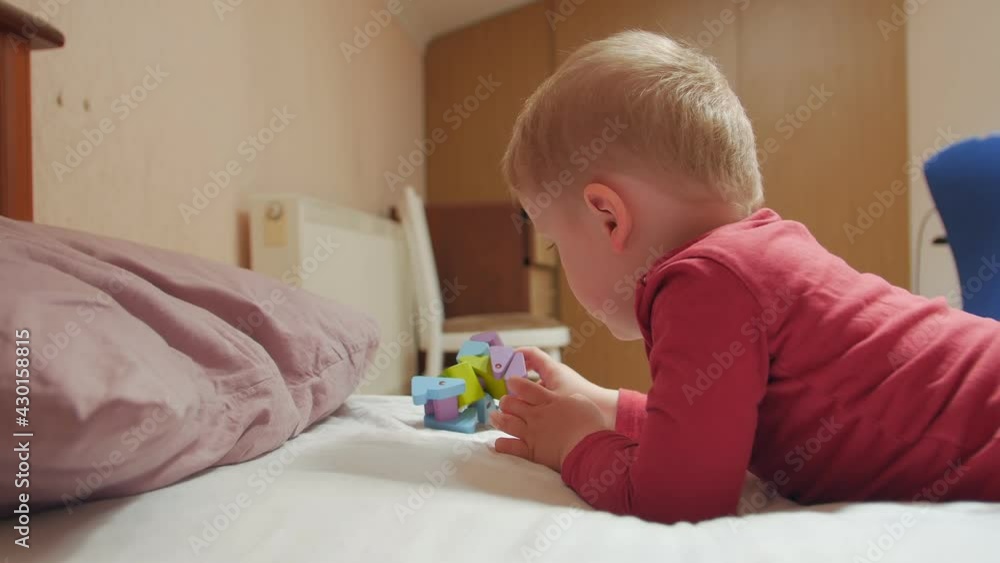 Little boy with toy bored at home in quarantine Little boy with toy bored at home in quarantine