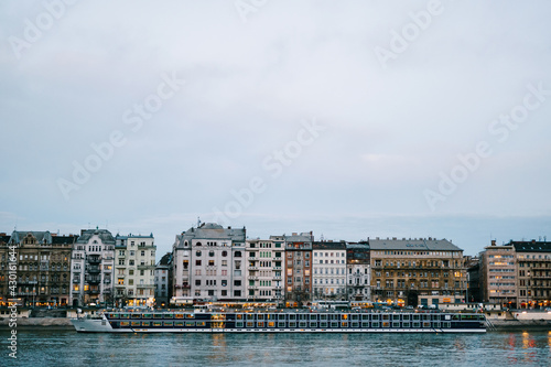 View of a huge ship sailing on the Danube River against the background of buildings in Budapest