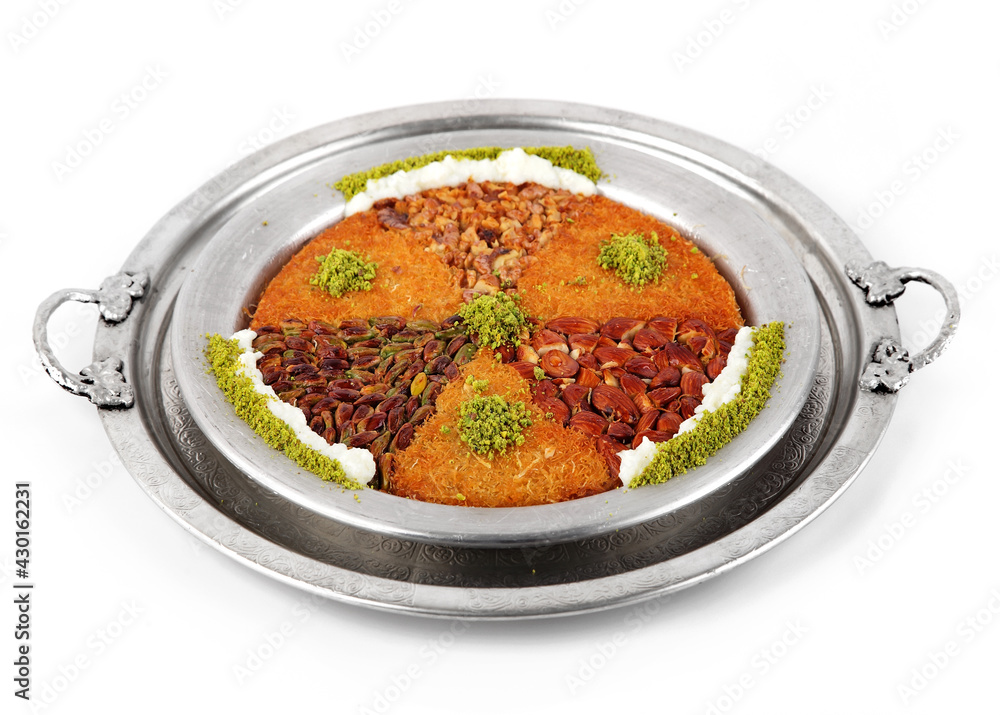 Turkish dessert kunefe, kunafa, kadayif with pistachio powder and cheese, served hot, very sweet. Turkish traditional dessert isolated top view Turkish dessert kunefe, kunafa, kadayif with pistachio powder and cheese, served hot, very sweet. Turkish traditional dessert isolated top view