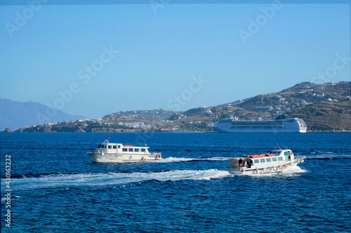 Boat and cruise liner is Aegean sea. Chora, Mykonos island, Greece photo