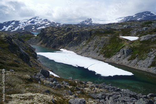 Famous Chilkoot Trail, glacier lake with snow in alpine zone, historic gold rush hiking route between Alaska and British Columbia, Canada photo