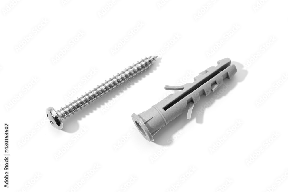 Plastic dowel and screw isolated on a white background. Expansion anchors or fixing dowel with chromed screw Plastic dowel and screw isolated on a white background. Expansion anchors or fixing dowel with chromed screw