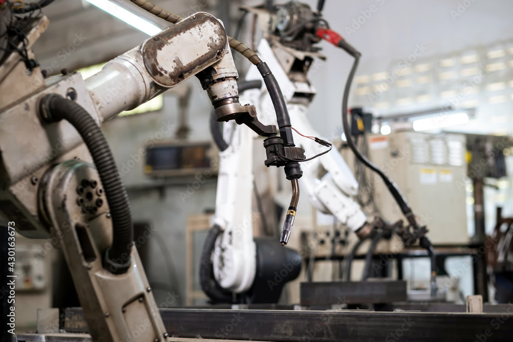 Obraz premium Robotic arm machine in the factory for welding metal. Automation system in factory. No people. Technology and industrial from ai concept