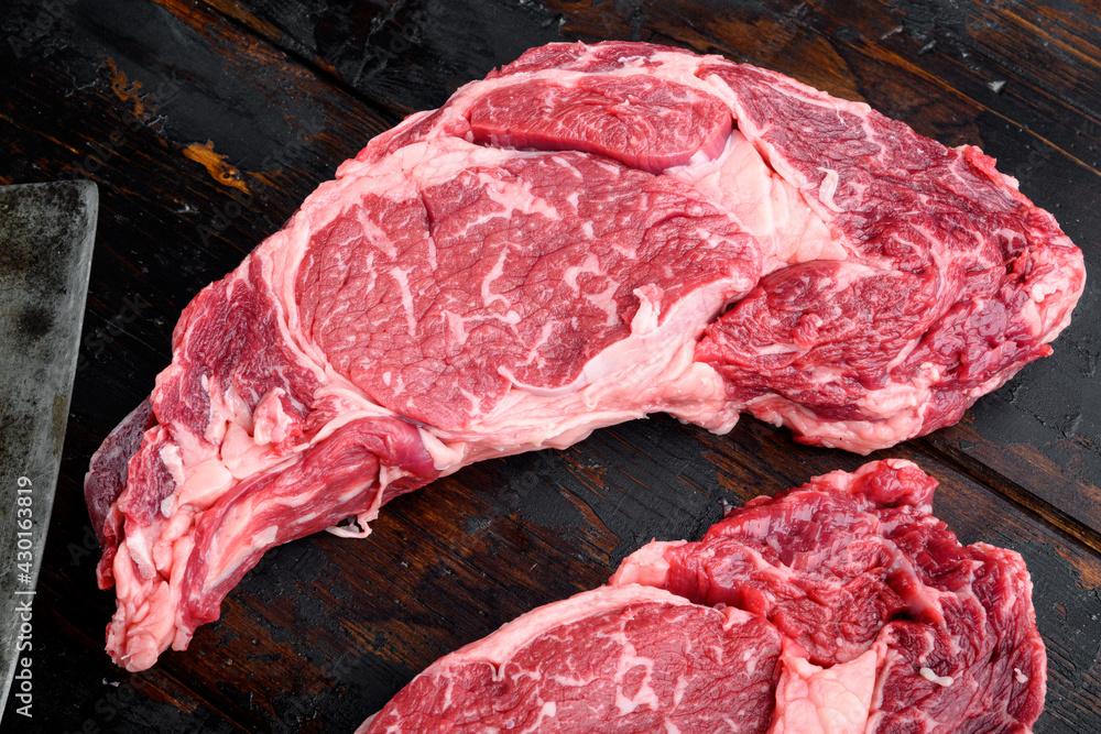 Raw fresh marbled meat Steak Ribeye Black Angus, on old dark  wooden table background, top view flat lay