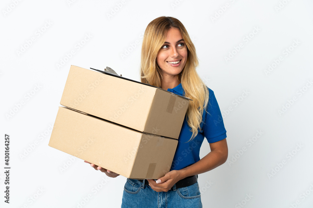 Young blonde Uruguayan delivery woman isolated on white background thinking an idea while looking up Young blonde Uruguayan delivery woman isolated on white background thinking an idea while looking up