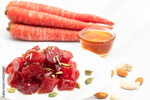 Ayurvedic Gajar Ka Murabba Or Gazar Murba Is Carrot Jam Made Of Carrots, Sugar Syrup And Bee Honey Shahad Madhu. It Can Be Preserved And Stored. Isolated On White Background photo