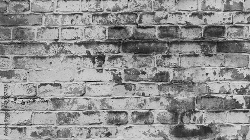 Texture, brick, wall, background facade brick wall black and white. Vintage old brick wall texture. Grunge stone wall horizontal background. Dilapidated building facade with damaged plaster.
