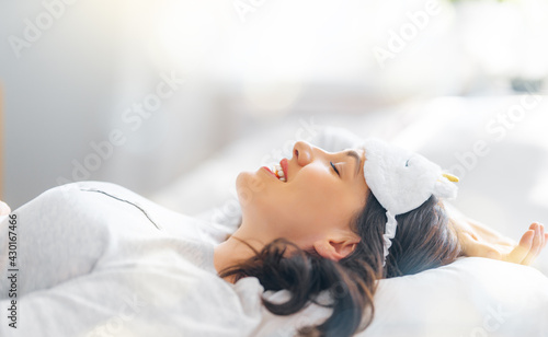 woman is waking up in the bedroom