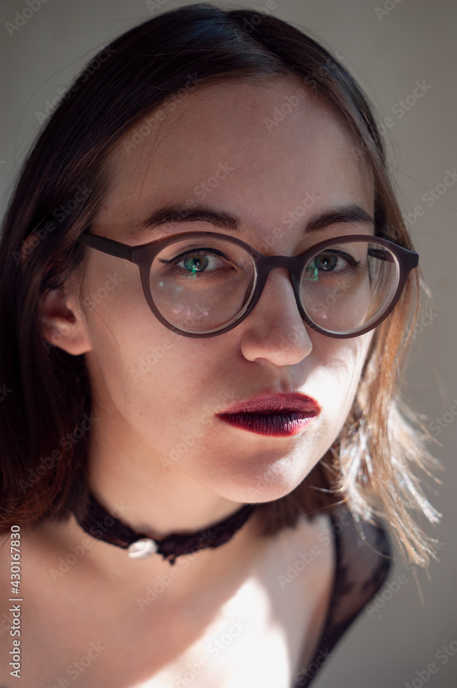 Portrait of woman in the round glasses with natural lighting Portrait of woman in the round glasses with natural lighting