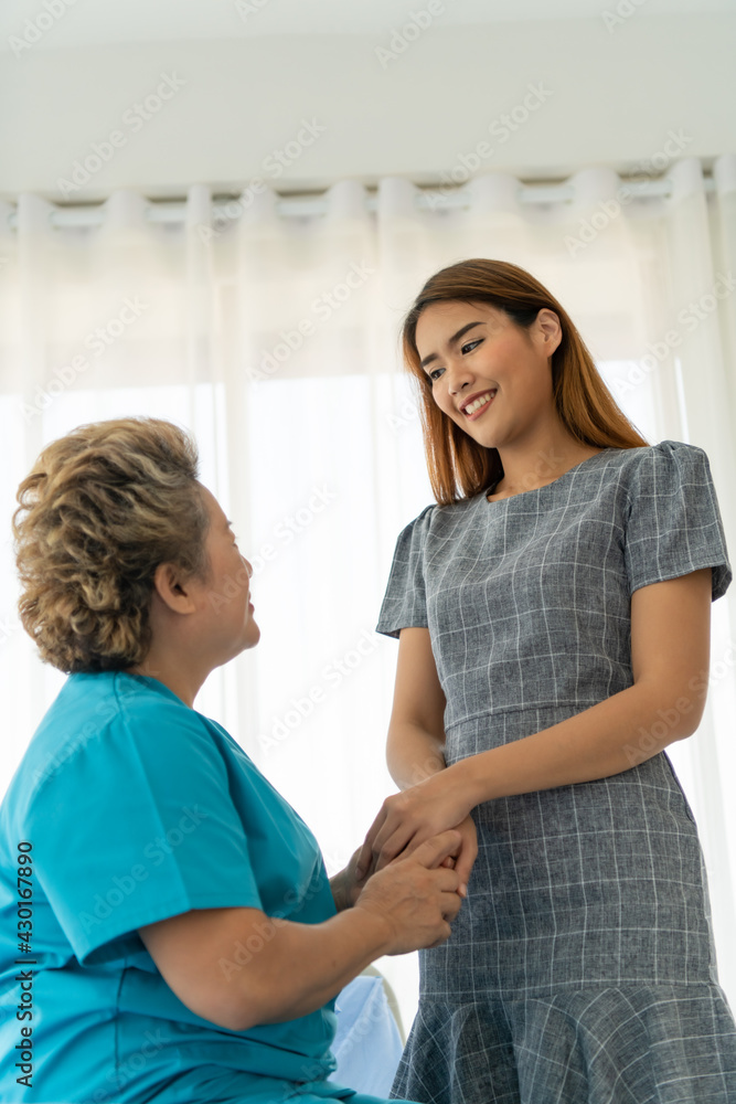 Daughter of a senior patient taking care and encouraging the mother Daughter of a senior patient taking care and encouraging the mother