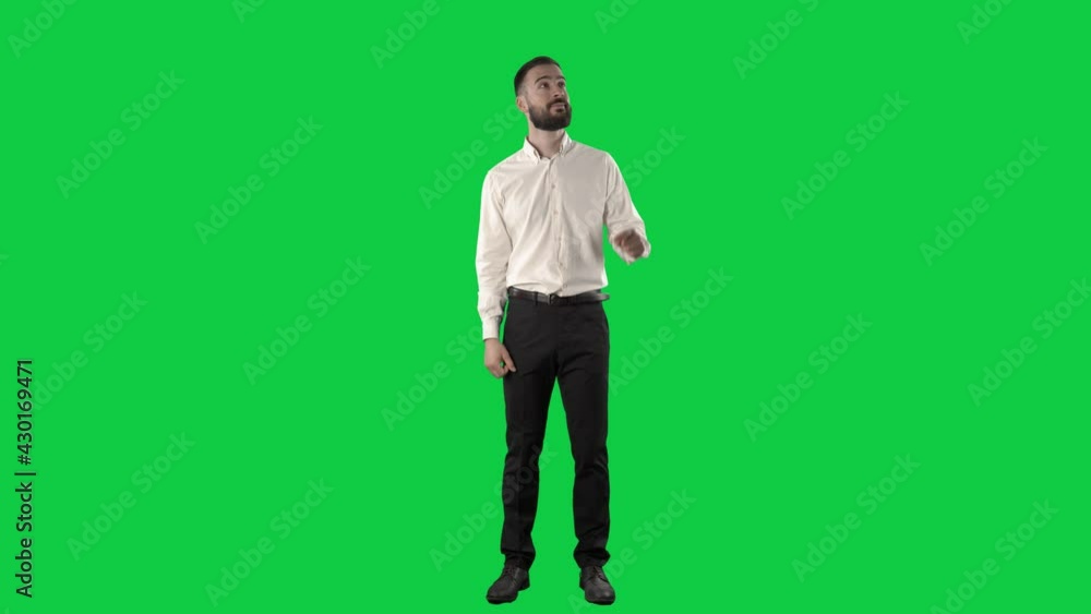 Handsome business man using interactive touch screen gestures. Full length on green screen chroma key background