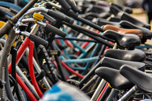 bicycles standing in a row in a parking lot, fragment, blurred image