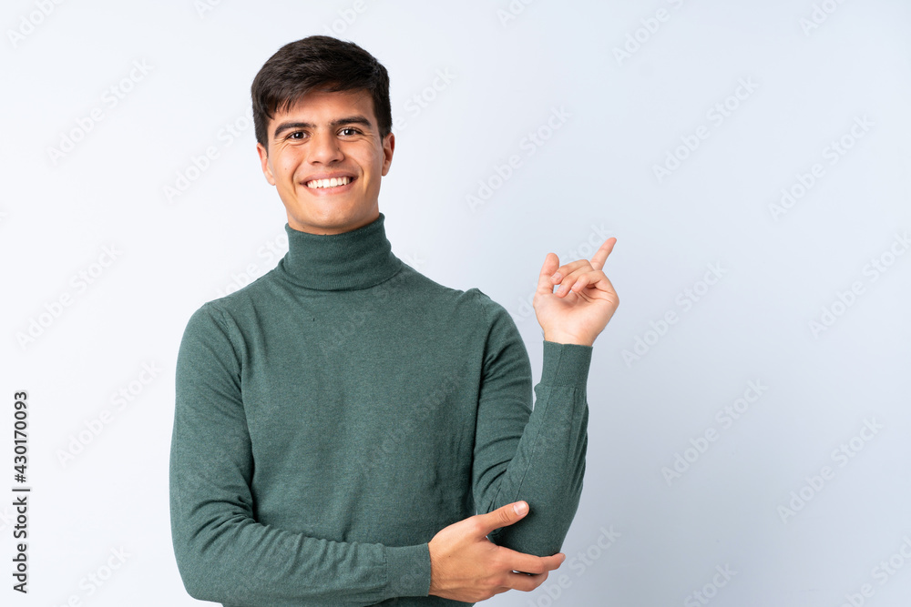 Handsome man over isolated blue background happy and pointing up Handsome man over isolated blue background happy and pointing up