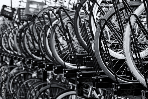 lots of bicycles stored in a parking lot fragment, blurred image