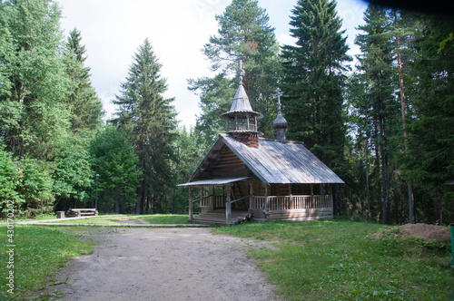 An old wooden church made of logs in a forest glade. 03 August 2017  Arkhangelsk  Russia.