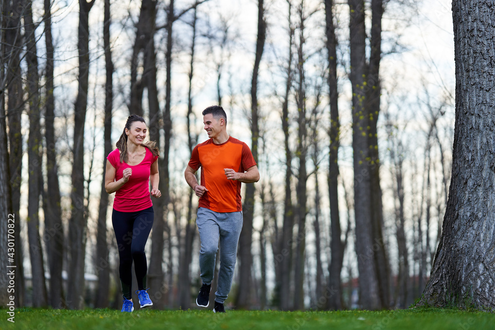 Young couple running in the park Young couple running in the park