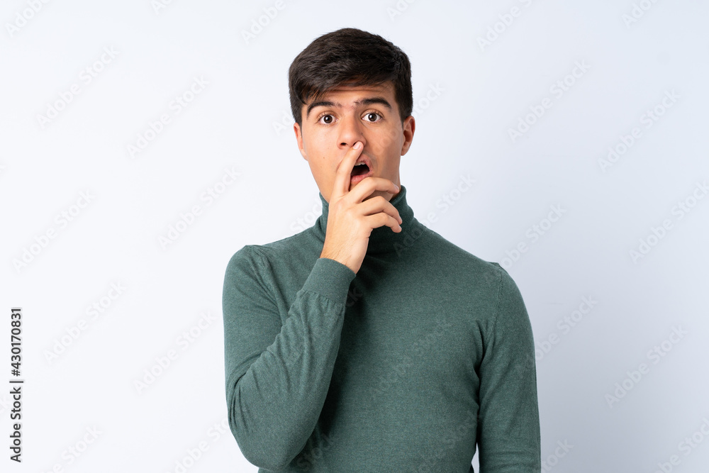 Handsome man over isolated blue background surprised and shocked while looking right Handsome man over isolated blue background surprised and shocked while looking right