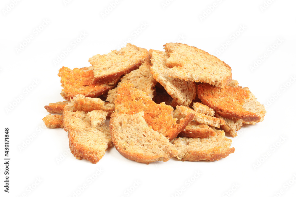 Toasted bread pieces isolated on white background. Pile of flavored crispy snack Toasted bread pieces isolated on white background. Pile of flavored crispy snack