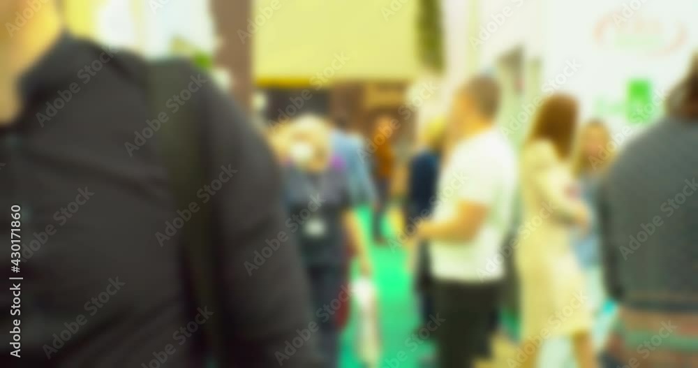 Blurred background on a business theme. Silhouettes of modern unrecognizable people inside a light mall. Blurred background on a business theme. Silhouettes of modern unrecognizable people inside a light mall.