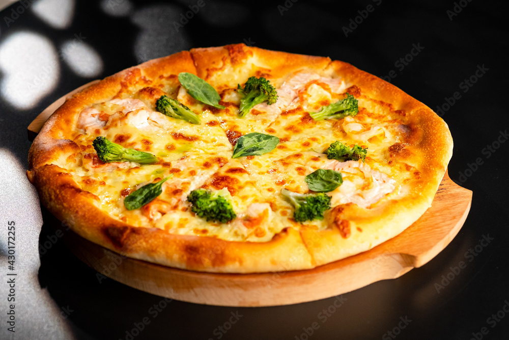 Pizza is not a wooden board. Black background. close-up. Pizza is not a wooden board. Black background. close-up.