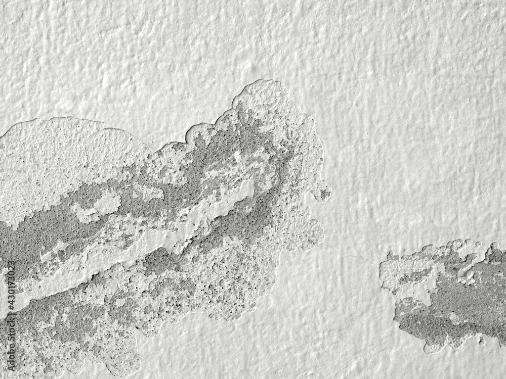 Closeup of peeling painted wall. Crack​ white​ wall​ texture. Old​ wall​ texture​ for​ background.