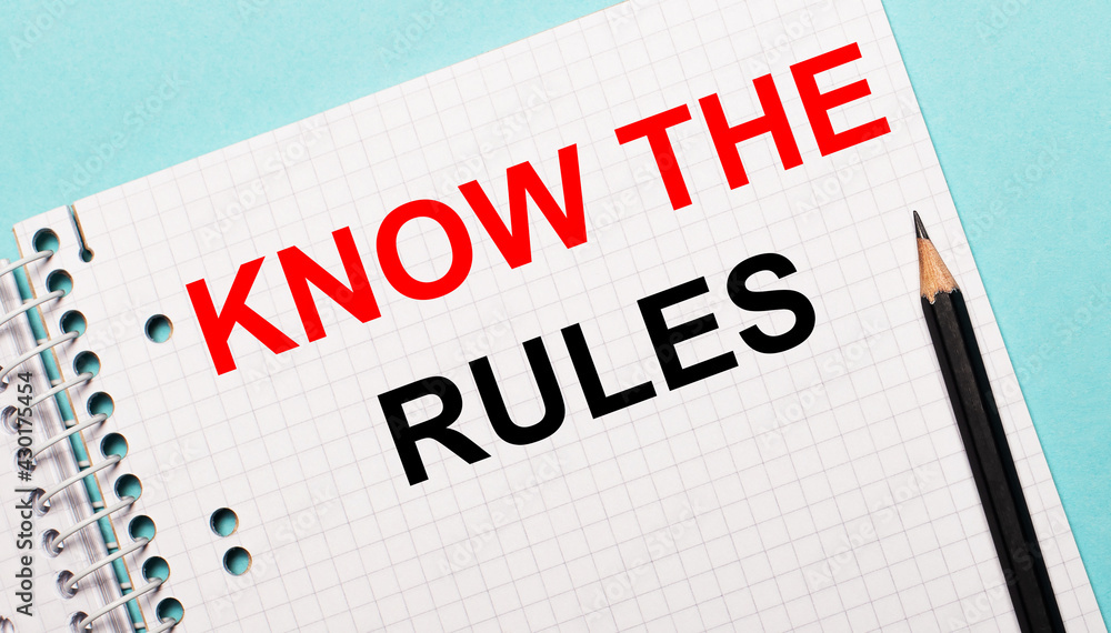 On a light blue background, a checkered notebook with the words KNOW THE RULES and a black pencil. On a light blue background, a checkered notebook with the words KNOW THE RULES and a black pencil.