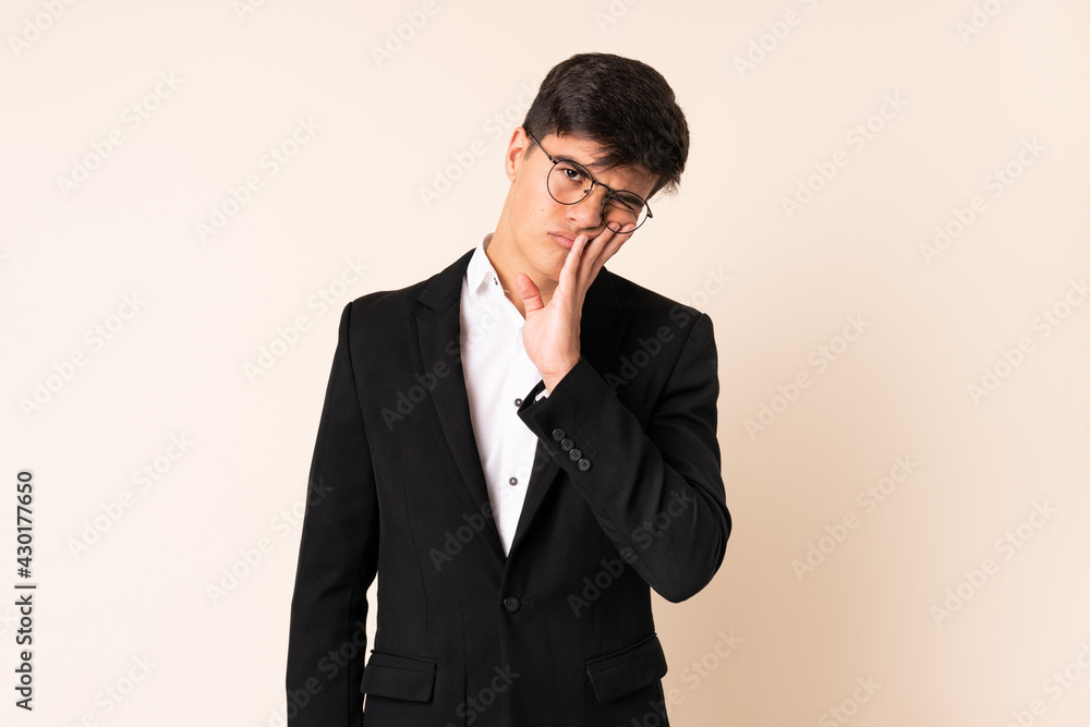 Businessman over isolated beige background unhappy and frustrated Businessman over isolated beige background unhappy and frustrated