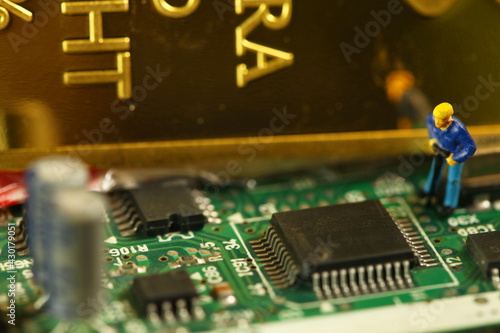 
Miniature worker figure model put on circuit board represent bitcoin mining and business finance concept related idea.
