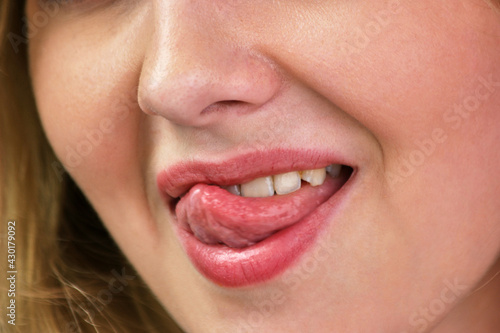 Young woman showing tongue and flirting.