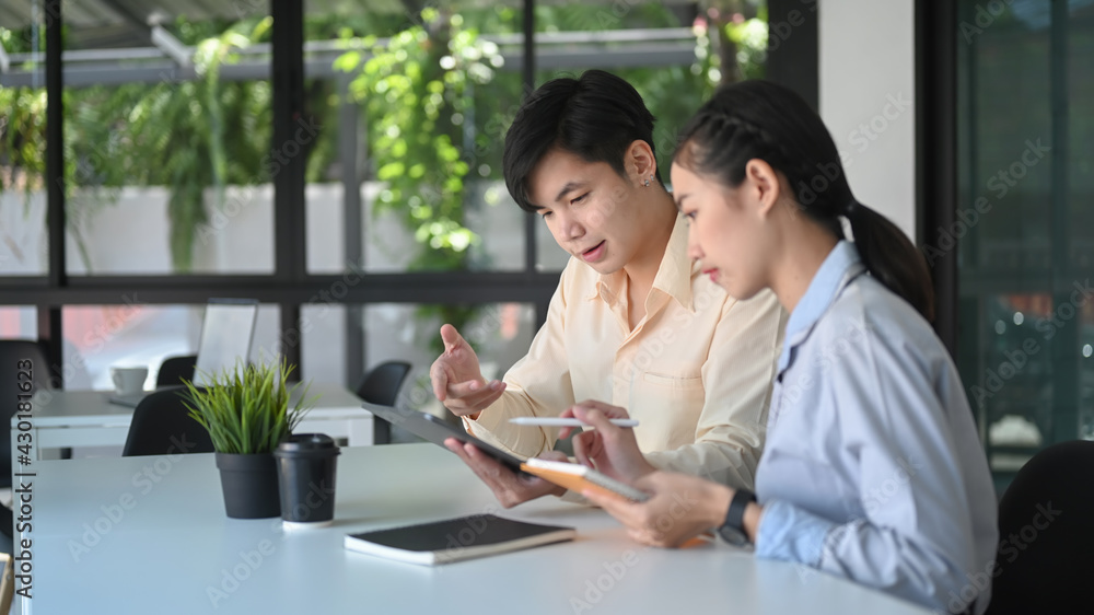 Two business consulting or talking with digital tablet on office workplace. Two business consulting or talking with digital tablet on office workplace.