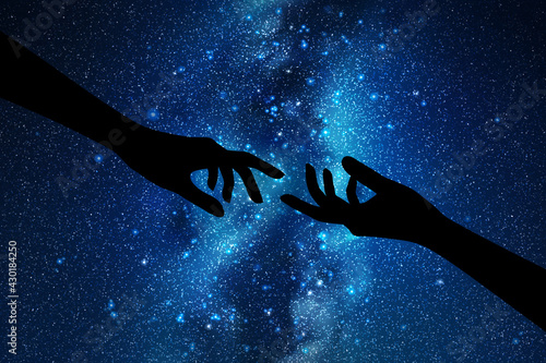 Reaching hands. Hand gesture silhouette. Night starry sky, Milky Way