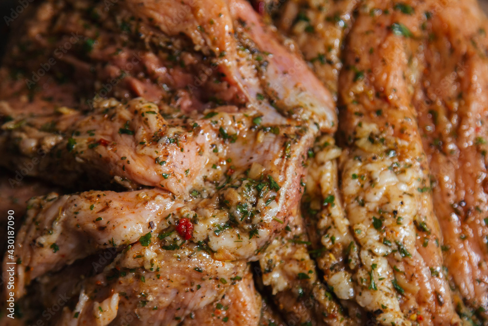 a piece of baked meat on the grill with spices lies on a wooden background close-up. Beautiful delicious fried steak ready to eat a piece of baked meat on the grill with spices lies on a wooden background close-up. Beautiful delicious fried steak ready to eat