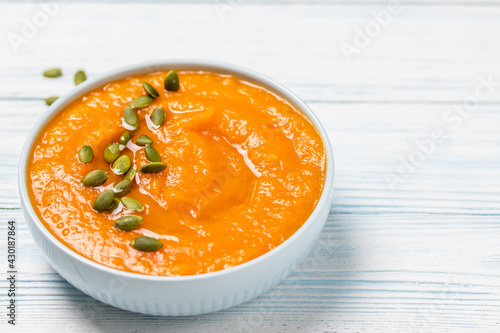 Creamy roasted pumpkin  soup  in a bowl. Space for text.