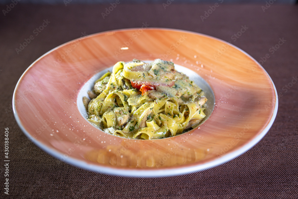 pasta with sauce and tomato on a plate in a restaurant pasta with sauce and tomato on a plate in a restaurant