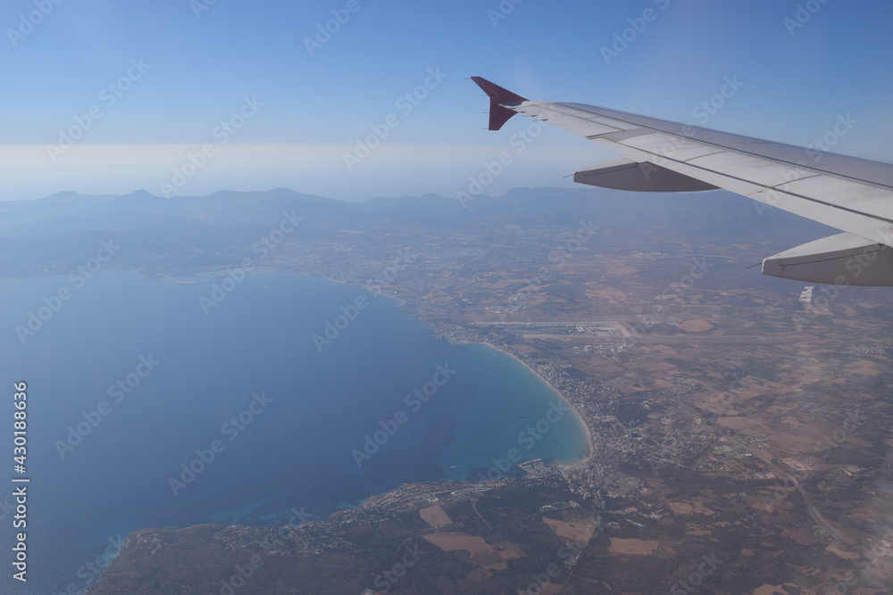 Fototapeta premium View from above, panorama view from an airplane, you can observe the blue ocean, islands, coastside, sand, beach, boats and some houses 