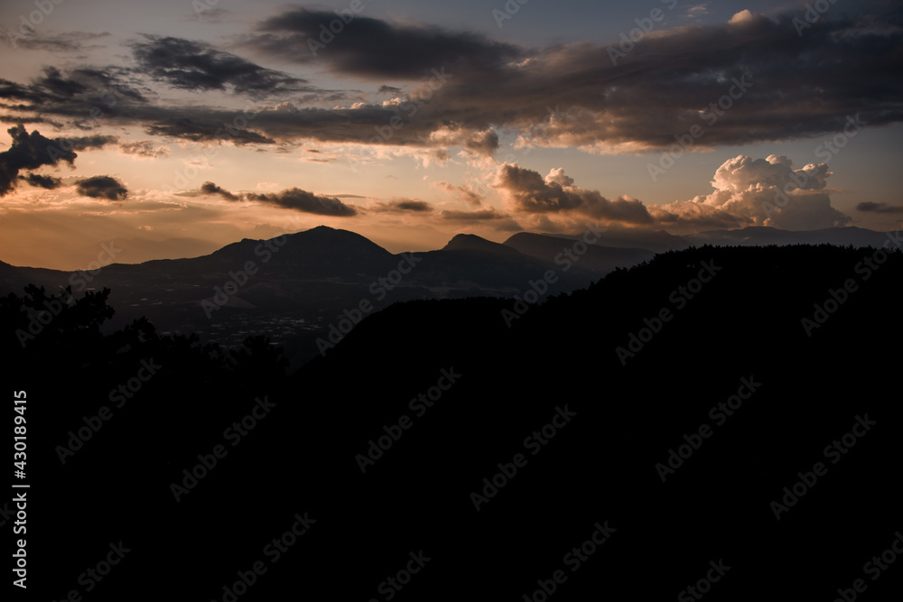 majestic mountain landscape with colorful vivid sunset on the cloudy sky, nature outdoor travel background.