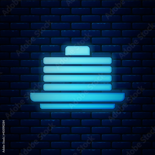 Glowing neon Stack of pancakes icon isolated on brick wall background. Baking with syrup and cherry. Breakfast concept. Vector