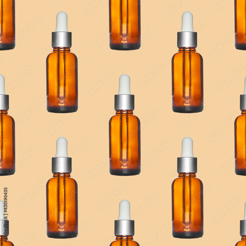 seamless background with amber dropper glass bottle on beige background seamless background with amber dropper glass bottle on beige background