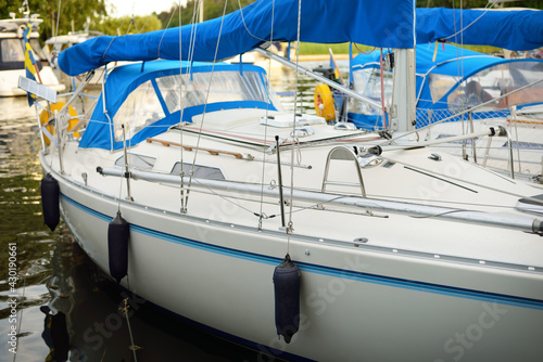 Elegant and modern sailboats moored to a pier in a yacht marina. Slandökalv, Mälaren lake, Sweden. Summer vacations, tourism, yachting, recreation, sport, leisure activity, racing, regatta, lifestyle photo