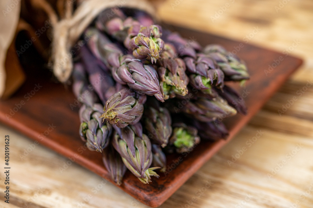 Fresh purple asparagus on and rustic background with copy space. Healthy dieting concept Fresh purple asparagus on and rustic background with copy space. Healthy dieting concept