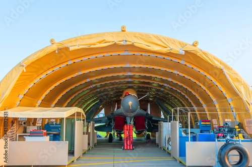 Air Force fighter jet in the parking lot in the mobile hangar tactical base, rapidly deployable complex. photo