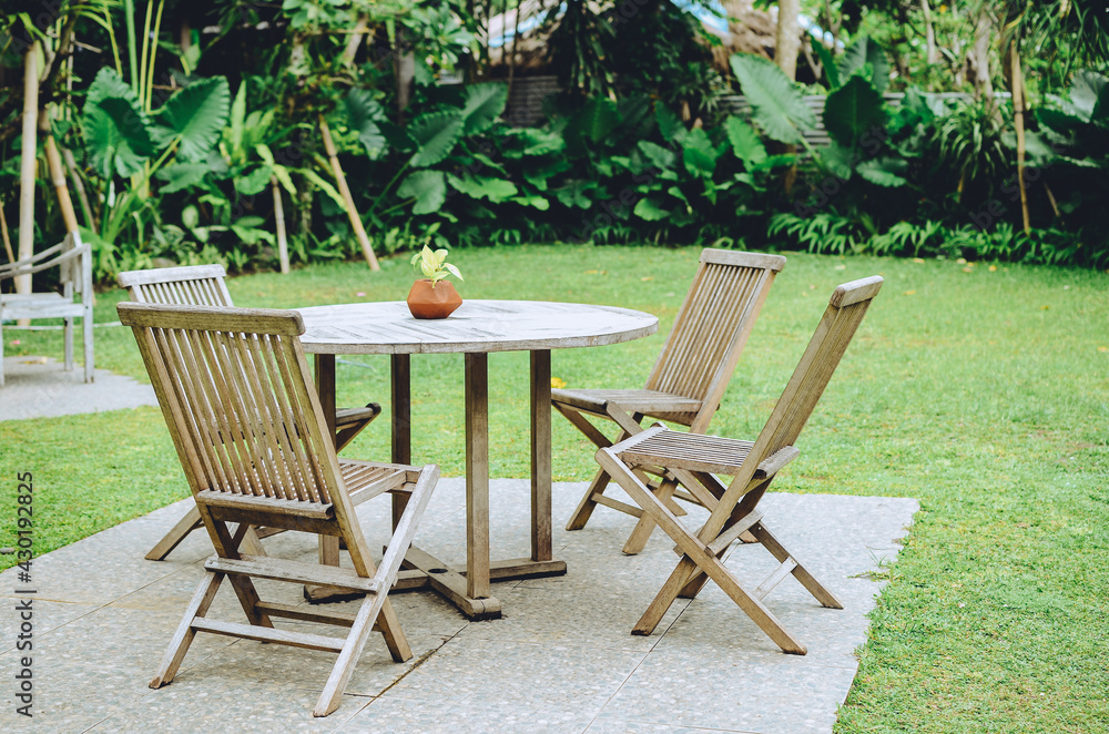 Wooden table and chairs in garden Wooden table and chairs in garden